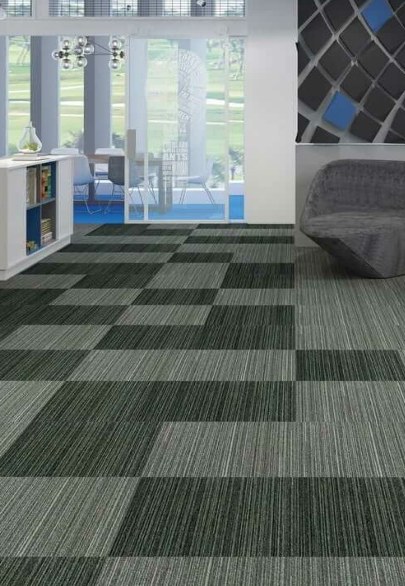 An office laid in green and charcoal carpet tiles in a chequered pattern.